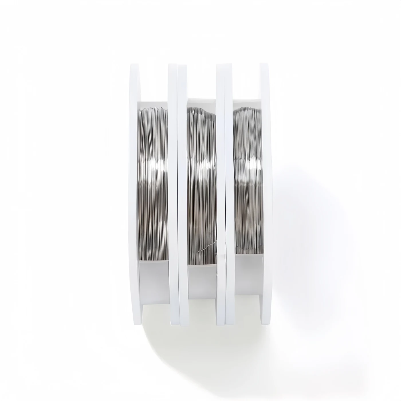 Side view of stainless steel orthodontic ligature wire spools